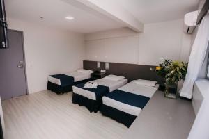 Postel nebo postele na pokoji v ubytování Pajuçara Hotel Express