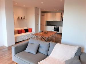 a living room with a couch and a table at Camélia Plein Soleil Bord de Plage in Coti-Chiavari