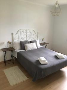 a bedroom with a large bed with two towels on it at La Casita del Alcázar in Medina de Pomar