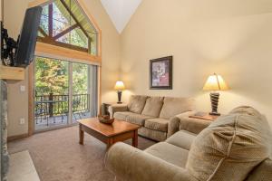 a living room with a couch and a tv at Gull Lake All-Season Getaway with Private Deck in Lake Shore