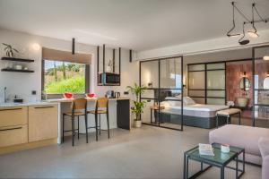 a kitchen and living room with a couch and a bed at Harmony Suites in Khelmáta
