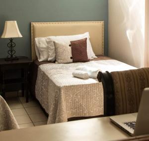 a bedroom with a bed with two towels on it at Casa Grande in San Miguel