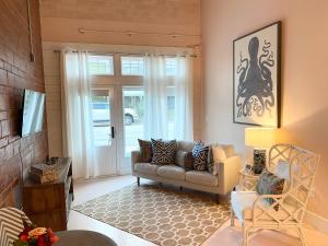 sala de estar con sofá y ventana en The Pink Room at Emily's On The Island en Galveston
