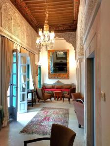 a living room with a chandelier and a couch at Dar el médina in Tunis