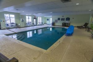 a large swimming pool in a large building at Holiday Inn Express and Suites Winchester, an IHG Hotel in Winchester