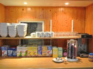 a shelf with bowls and cups on top of it at Old Castle Farm Guest House in Brecon
