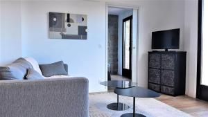 a living room with a couch and a table at Camélia Plein Soleil Bord de Plage in Coti-Chiavari