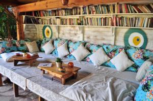a living room with a couch with pillows and a table at Turan Hill Lounge in Faralya