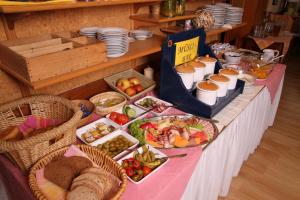a table with a buffet of food on it at Pension Strohmer in Rust