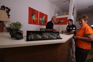 three men standing at a counter in a room at Pension Strohmer in Rust