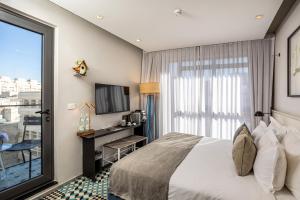 a hotel room with a bed and a window at Bezalel Hotel - an Atlas Boutique Hotel in Jerusalem