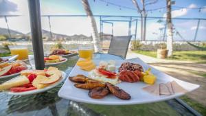 a table with two plates of food on it at Hotel Mozonte San Juan del Sur in San Juan del Sur