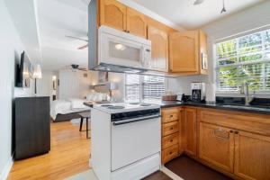 a kitchen with a white stove and a sink at The Savannah - Perfect Couple Getaway! in West Palm Beach