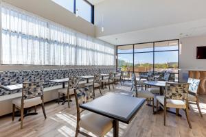 a dining room with tables and chairs and windows at Best Western Plus Executive Residency Phoenix North Happy Valley in Phoenix