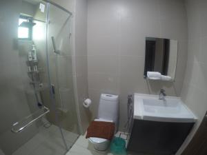a bathroom with a shower and a sink and a toilet at Green Haven Homestay in Pasir Gudang