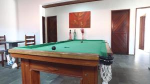 a pool table in the middle of a room at Pousada Caribe Sul in Barra do Cunhau