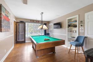 a room with a pool table and a blue chair at Nashville TN Vacation Rentals in Nashville