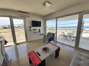 a living room with a view of the ocean at Costa Mar in Puerto Madryn