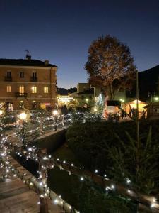 a street with lights in a city at night at Casa Lumiere in Aosta