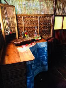 a room with a wooden table in a house at Pension TUPUNA in Haapu