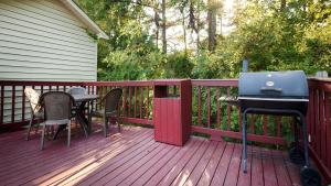 a deck with a grill and a table and chairs at Best Western Fairwinds Inn in Cullman