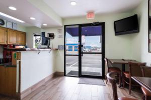 a kitchen with a table and a sliding glass door at Econo Lodge Inn & Suites Williams - Grand Canyon Area in Williams