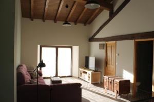 Casa Rural Abuela Luci : غرفة معيشة مع أريكة وتلفزيون