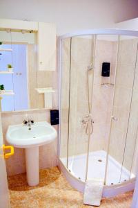 a bathroom with a shower and a sink at Aparthotel Santa Maria Beach in Santa Maria