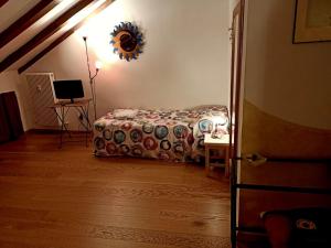 a bedroom with a bed and a table and a mirror at B&B Eden in Trento