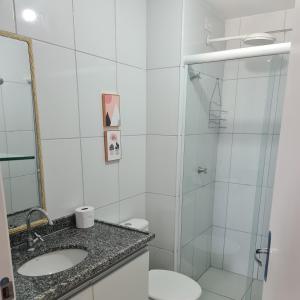 a bathroom with a shower and a toilet and a sink at Flat 308 in Teresina