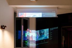 A television and/or entertainment centre at F1RST Suite Apartment & SPA