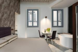 A bed or beds in a room at F1RST Suite Apartment & SPA