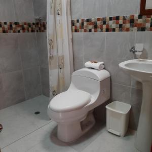 a bathroom with a toilet and a sink at Nirvana House Calima Darien in Calima