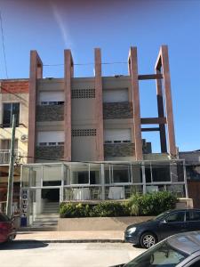 a large building with a car parked in front of it at Hotel Americana in Punta del Este +34 photos