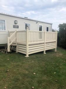 a white fence on a porch of a rv at The Summers residence in Selsey