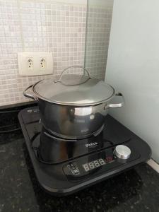 a pot on top of a stove in a kitchen at Apart Hotel Marinas Tamandaré in Tamandaré