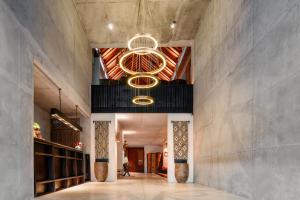 a lobby with a large chandelier hanging from the ceiling at Bisma Eight - CHSE Certified in Ubud