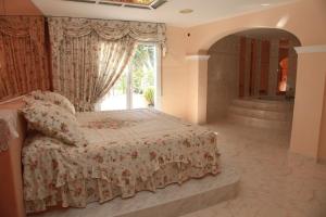 a bedroom with a bed and a large window at Hotel Villaclara in Hospitalet de l'Infant