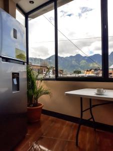 a table in a room with a large window at Millennium Apartment in San Pedro La Laguna