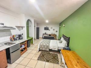 a bedroom with a bed and a green wall at Casa San Andrés in Cholula