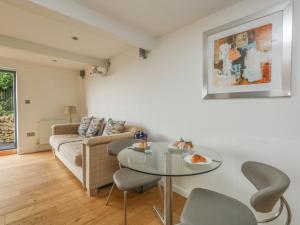 a living room with a table and a couch at Burton Bay in Burton Bradstock