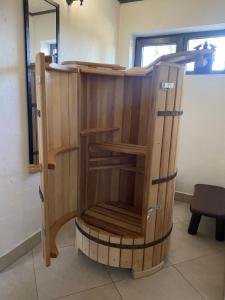 a wooden cabinet with a chair in a room at Феєрія Лісу in Skhidnitsa