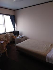 Postel nebo postele na pokoji v ubytování ニャー助のホテルん