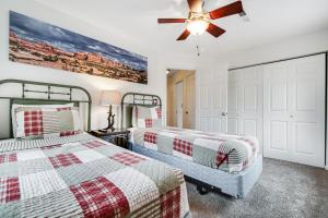 a bedroom with two beds and a ceiling fan at Cottonwoods 57 in Moab