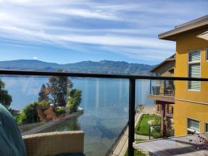 a view of a lake from a balcony at Wine Country Luxury Waterfront Condo in West Kelowna