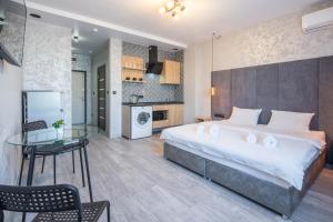 a bedroom with a large bed and a glass table at Гостиниц NET на Большевистской in Novosibirsk