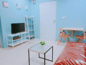 a living room with a couch and a table at Near boxing center, 1BR apartment, Sofa bed, Wifi in Chalong 
