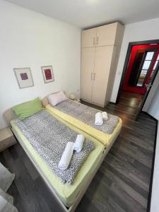 two beds in a room with towels on them at Apartments Rosina in Plovdiv