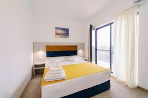 Postel nebo postele na pokoji v ubytování NOVUS Hotel + 37 fotografií