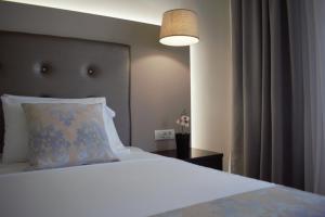 Postel nebo postele na pokoji v ubytování Oscar Hotel